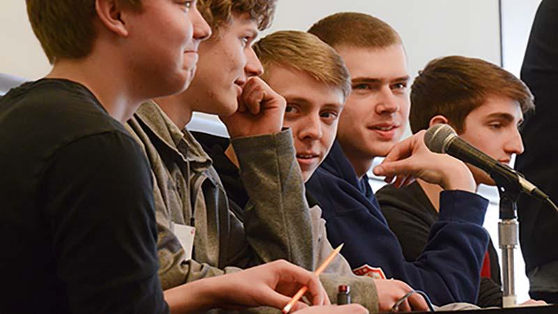 Male students answer a question at the quiz bowl